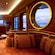 Inside a cozy lounge, a semicircular bench has cushions with leather straps